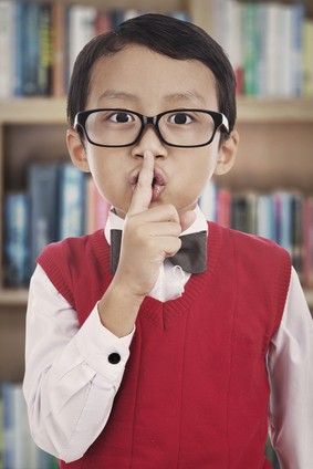 Student gesturing silence