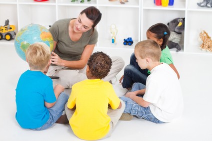 preschool teacher teaching kids about globe