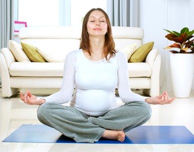 Beautiful Pregnant Woman Doing Yoga at Home